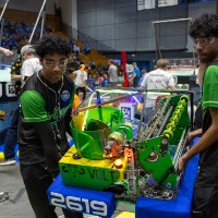 Two teammates move their robot off the field